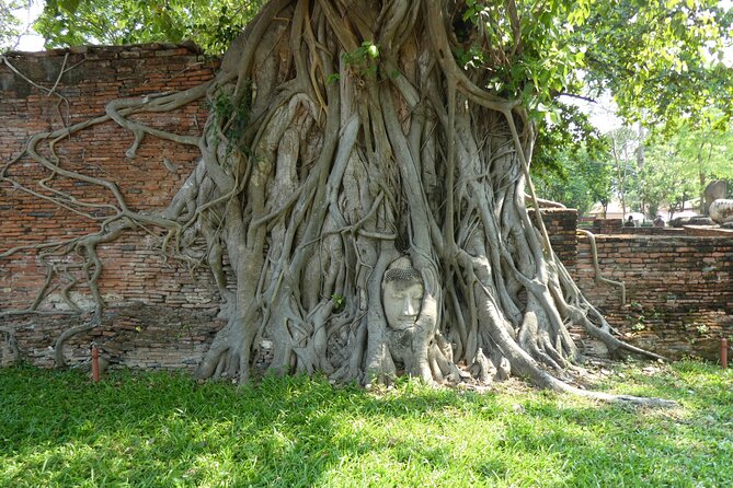 Ayutthaya Famous Temple & Scenic Boat Tour From Train Station - Wat Yai Chai Mongkhon: towering chedi and the statue-lined feel