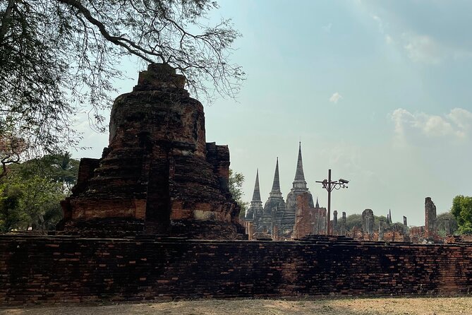 Ayutthaya Historical Old Capital day Tour from Bangkok - Wat Mahathat: the tree-root Buddha head that steals the show