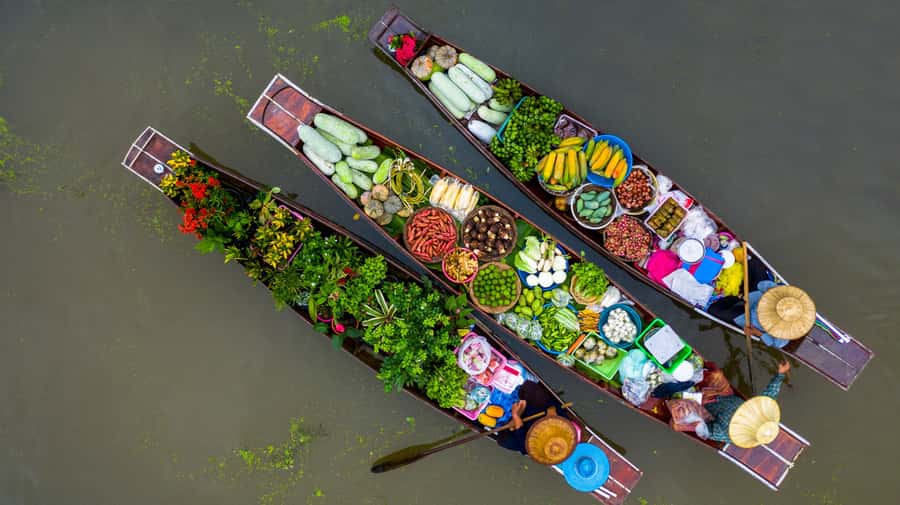 From Bangkok: Maeklong Railway and Floating Market Food Tour - Damnoen Saduak Floating Market by longtail boat: Cool water, crowded edges